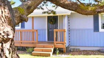 A warm, welcoming entry invites you in with a simple front porch, easy steps, and a clean, approachable design that immediately feels like home.