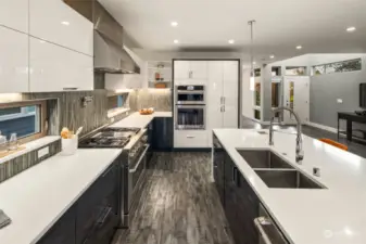 A chef's dream kitchen! Jenn-Air stainless steel appliances include a gas range with 4-burner cooktop and griddle, a wi-fi enabled electric convection oven, built-in microwave, French door refrigerator with water dispenser and ice maker, and dishwasher.