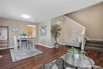 View of the start of the stairs, dining area and hall to kitchen and family room