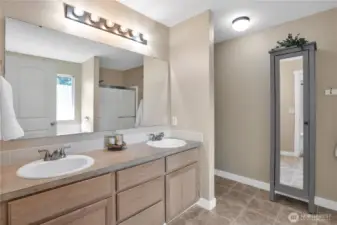 Primary bathroom with double sink vanity, shower and bathtub.
