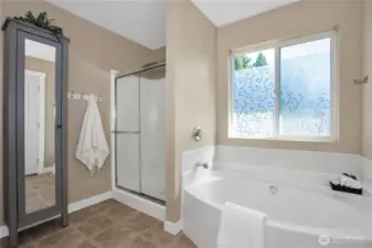 Another view of the bathroom with large bathtub.