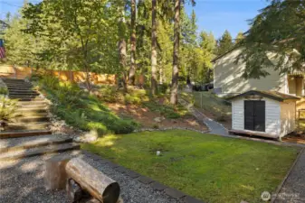 The yard is so big! There is an upper yard up the stairs and a lower yard. The large shed has loads of storage.