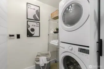 Large washer and dryer closet offers pantry options and extra storage