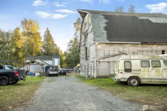 side view of the barn and three additional dwellings.