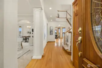 Hardwood entry, dramatic stairway and formal living and dining greets guests.