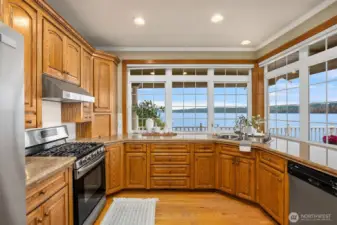 Kitchen so many windows to take in the amazing views and lots of cabinets.