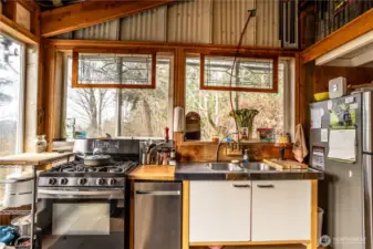 Kitchen area with dishwasher, gas stove and refrigerator