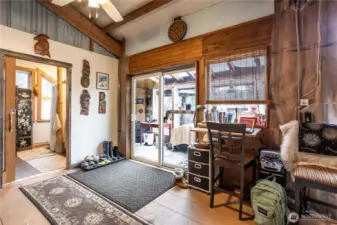 Enjoy effortless indoor-outdoor flow via the sunroom's sliding glass door, while the bathroom offers a discreet pocket door entrance