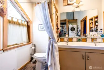 Thoughtfully designed with a double-basin vanity and a discreet toilet alcove