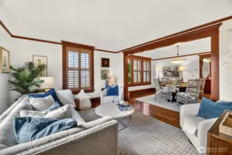Gorgeous formal living room with plantation shutters, wood moulding and picture rail.