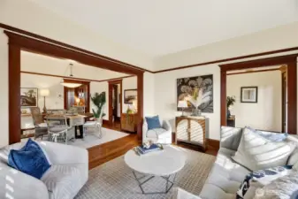 Living room open to the dining room with a large cased opening for a spacious feel.