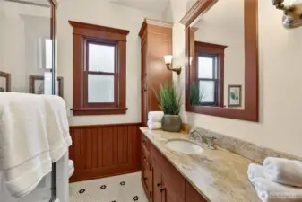 Spacious bathroom with hex tile and lots of storage.