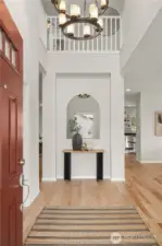 Grand 2-story foyer with open spindle handrail makes for a great first impression. The entryway is adjoined by glass french doors into a lovely den/study.