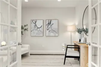 A private den or study is ideally positioned just off the foyer, creating a versatile and functional space perfect for a home office or quiet retreat. Elegant glass French doors provide both separation and natural light, while a front-facing window overlooks the covered porch, filling the room with soft, welcoming daylight.