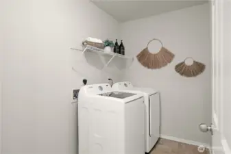 Upper level laundry room with additional storage space.