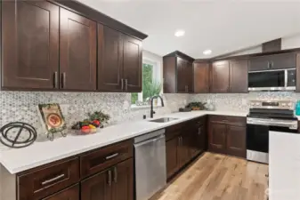 Kitchen w/Eating Bar Island, Recessed Lighting and Window overlooking the backyard.