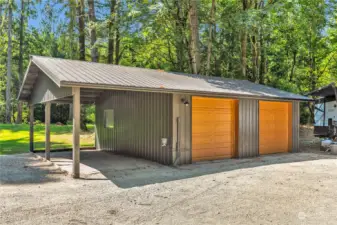 Large wired, 2 car oversized garage with carport.