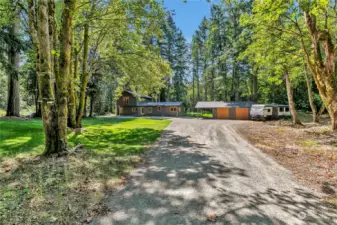 Serene inviting driveway to your property.  Plenty of room for RV parking and vehicle parking.