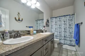 Second bathroom with dual sinks.