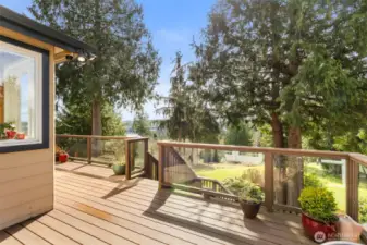 Stretching across the entire length of the house, this beautiful composite deck has room for everyone, and is a perfect way to enjoy the partial view of the bay.