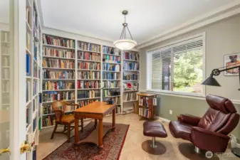 Warm and cozy, the office/library space enjoys walls of built-ins and a place to relax, rain or shine.