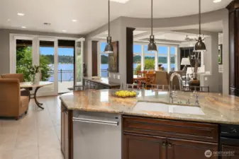 The casual dining nook flows seamlessly to the covered outdoor entertainment deck with overhead radiant heating.