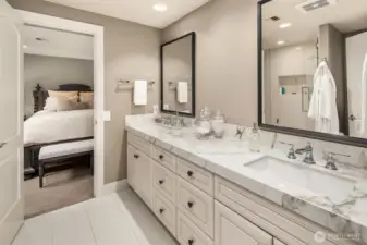 Shared dual vanity 3/4 disigner bathroom between the 2 guest chambers on the lower level.