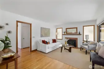 Hardwood floors run throughout most of the main level. The living room has a fireplace with a wood-burning insert and mahogany mantel which matches the original mahogany trim.