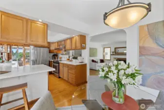 View from dining room toward kitchen. To the left of the refrigerator is the study nook, stairs to lower level, and entrance to the family room.