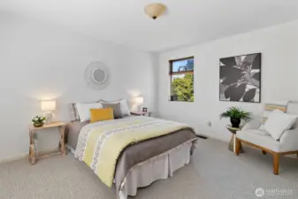 Spacious primary bedroom with new carpet.