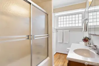 Full bathroom on main floor; glass block window lets in so much natural light while maintaining privacy.