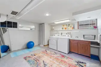 Bright and open laundry/flex space greets you upon entering the lower level of the home.