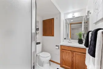 Lower level bathroom with shower is conveniently located near bedroom and flex space.