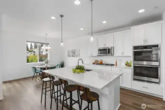 Gorgeous kitchen featuring Quartz countertops, stainless appliances and tons of storage!
