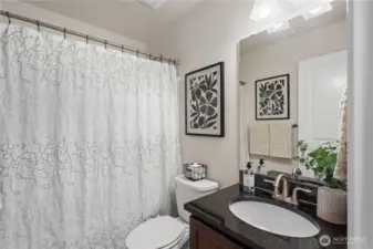 Full bath off the hallway, right by the second bedroom.