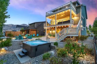 Exterior twilight view of home and outdoor living area with private spa.