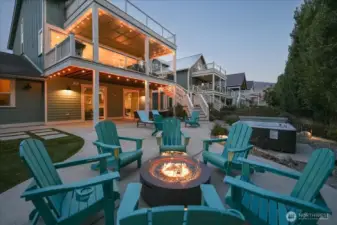 Exterior twilight view of outdoor fire pit and outdoor living area.