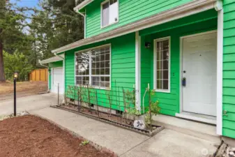 Welcoming front entry at 513 Hidden Forest Dr SE, Olympia — featuring a covered porch, large picture windows, and fresh exterior paint. Surrounded by evergreens and set in a quiet cul-de-sac community, this home offers a peaceful Pacific Northwest feel right from the front door. No HOA!