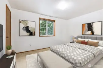 Bright and spacious upstairs bedroom featuring a large window with wooded views—perfect for a serene retreat.