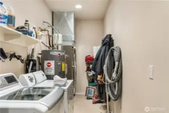 Utility room off the garage includes to water heaters.