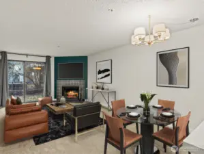 Open living room and dining area with cozy fireplace.