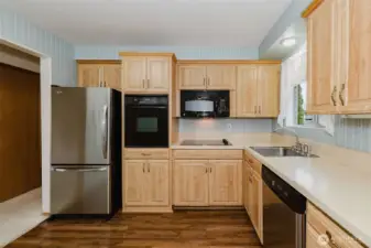 Kitchen has new floors and updated cabinetry and appliances