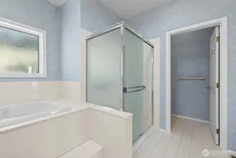 Primary bathroom with walk-in closet (staged)