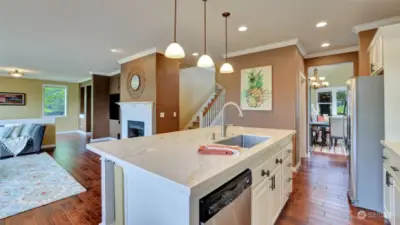 Painted wood cabinetry, quartz counters, and stainless steel appliances