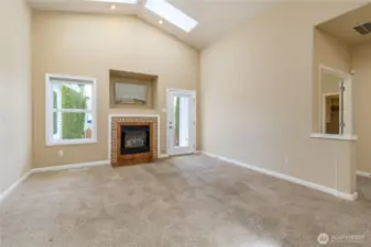 Family room has gas fireplace, bright skylights