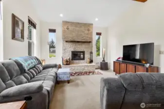 Floor to ceiling stone fireplace captivates in this living room