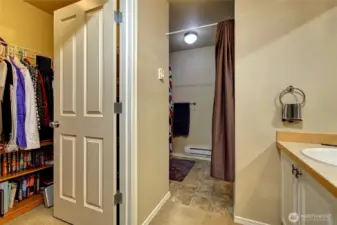 Private primary bathroom with a walk in closet
