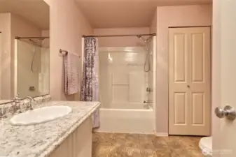Roomy guest bathroom with a  convenient linen closet