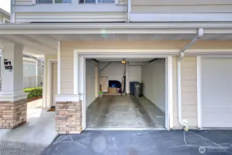 Over sized garage with extra storage area leading under the stairs as well