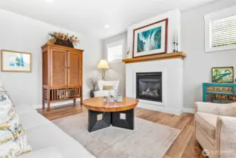 Cozy gas fireplace elegantly complete with stucco finish & warm wood mantel